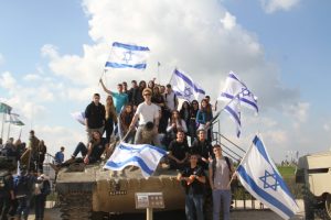 נערים על טנק עם דגלי ישראל